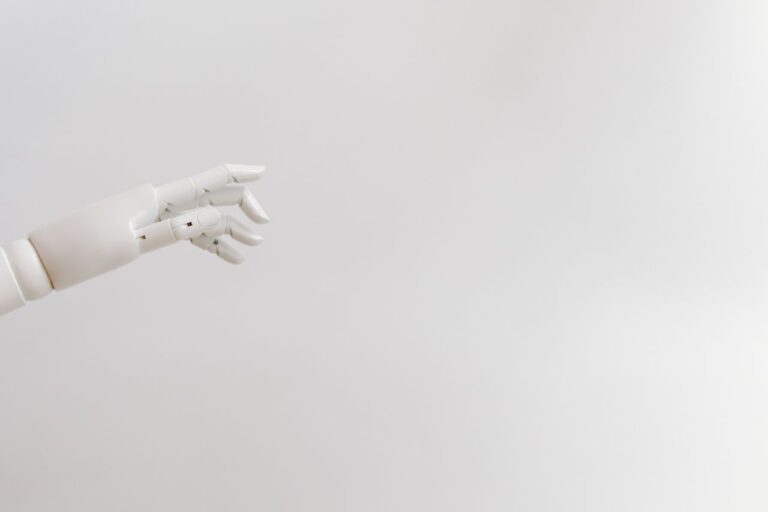 The Art of Drawing Readers In: Your attractive post title goes here Minimalist image of a robotic hand reaching out on a white background.